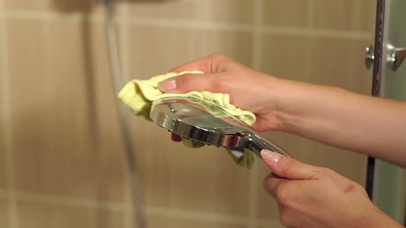 Girl Cleans a Shower Head in the Bathroomcloseup