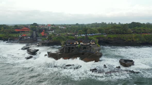 Empty Tanah Lot Temple on Dark Rocky Cliff at Sea During Dangerous Weather