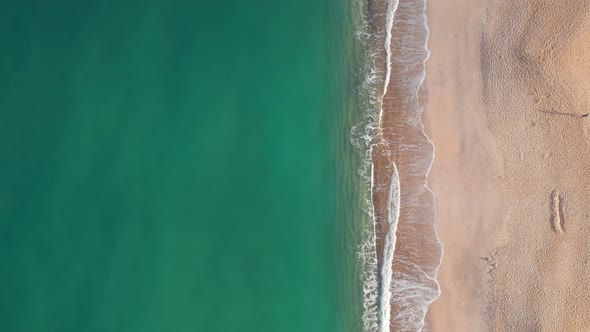 Aerial Top Down Drone Shot Above an Empty Sand Beach