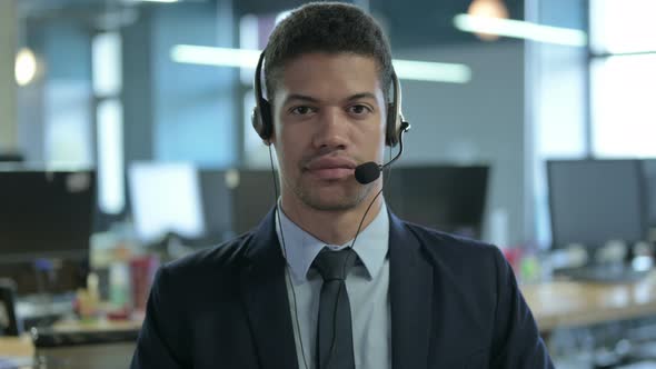 African Businessman with Headset Looking at Camera, Call Center