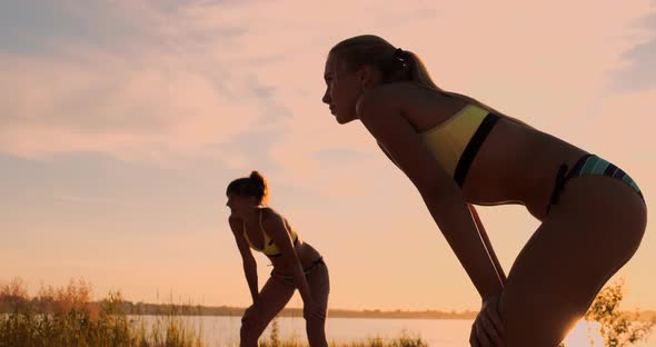 Group of Young Girls Playing Beach Volleyball During Sunset or Sunrise, Slow Motion,