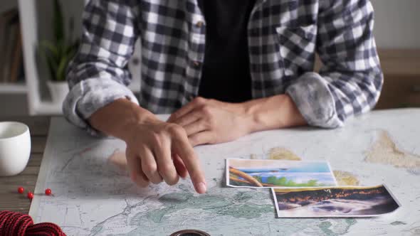 Tourist Traveler Plans A Hiking Trip In The Expected Vacation, Shows Points On The World Map A Route