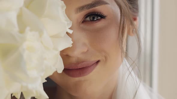 Closeup of Beautiful Lovely Stylish Bride Girl Looking at Camera and Smiling with Flowers Bouquet