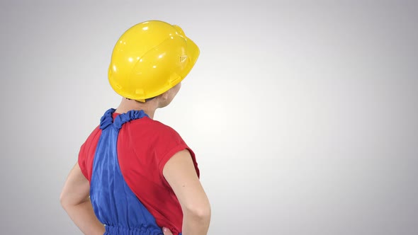 Engineer Construction Worker Woman Turning To Camera and Smiling on Gradient Background.