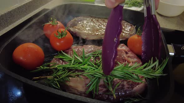 Cooking Steak with Rosemary and Cherry Tomatoes on the Grill