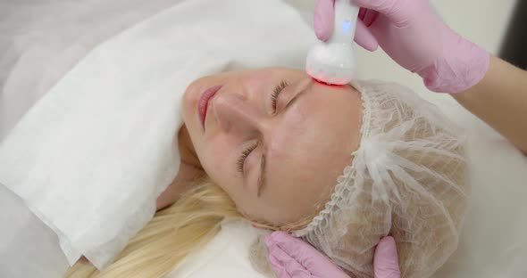 Attractive Woman In A Cosmetology Clinic Receives A Phonophoresis Procedure For The Skin 