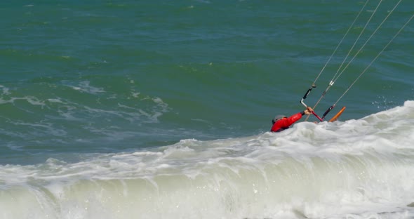 Active People Practicing Human Kitesurfing and Windsurfing