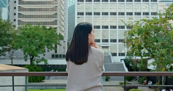 Woman look at the view with business tower background