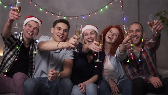 Happy Young People Drinking Champagne From the Glasses During Celebrate New Year or Christmas Eve