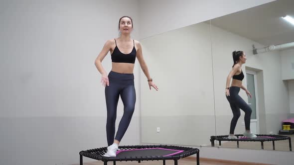 athletic girl are engaged in jumping on sports trampoline Video HD Slow motion