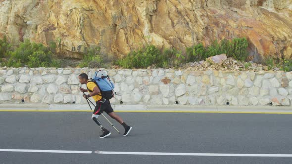 Sporty mixed race man with prosthetic leg hiking