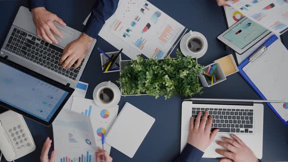 Top View of Company Teamwork Sitting at Desk Table Planning Management Investment