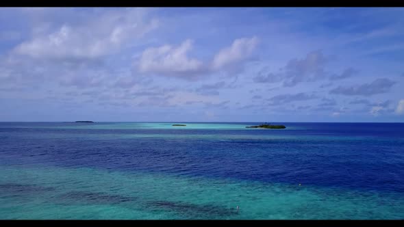 Aerial scenery of relaxing coast beach holiday by transparent water with bright sandy background of 