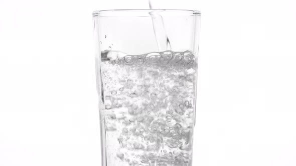 glass of water. pouring water in glass, white background