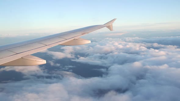 Aerial View of Sunrise Through Airliner Window