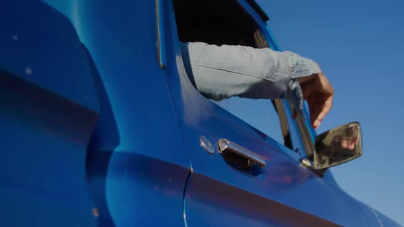 Young man on a road trip in pick-up truck