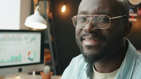 Portrait of Smiling African American Man at Home Workplace