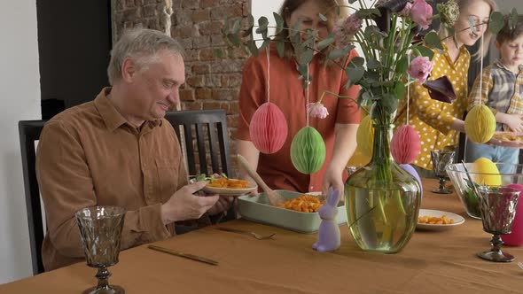 Family at Easter dinner sitting at the table at home