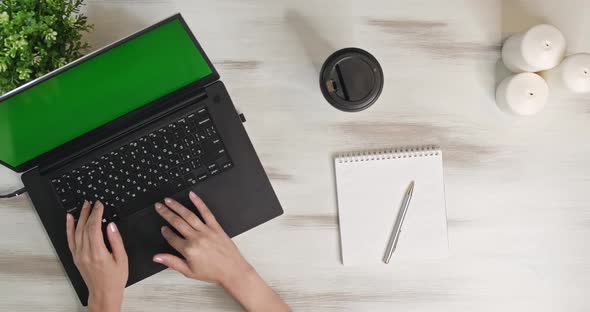 Above Shot in Move Woman Using Laptop Computer on Office Table Background. Girl Makes Notes and