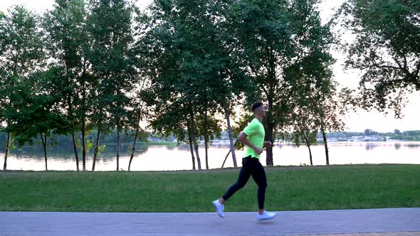 Young Sportsman Runner in Sportswear Running at River Outdoor Stamina