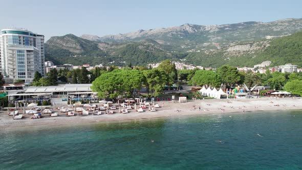 Aerial View Budva Beach By Sea with Sun Loungers and People Seashore Montenegro