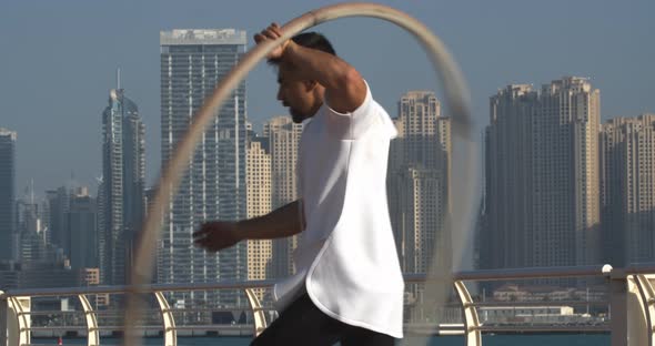 Sportsman is Spinning a Big Hoop Around Himself Wheel Gymnastics in Dubai
