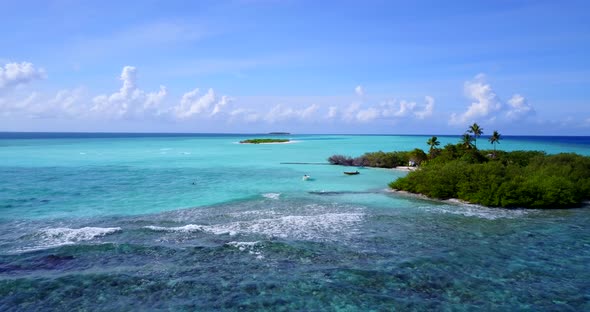 Tropical drone tourism shot of a white sand paradise beach and blue water background in 4K