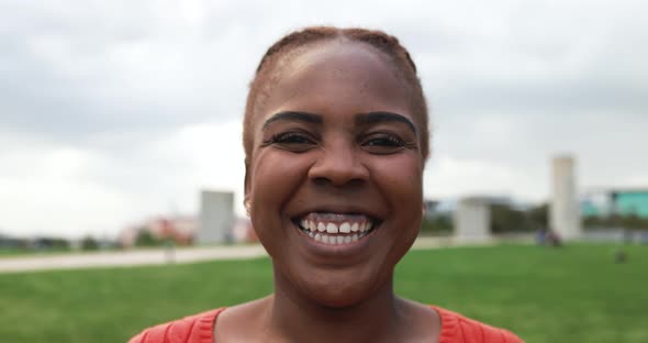 Curvy african woman smiling on camera outdoor