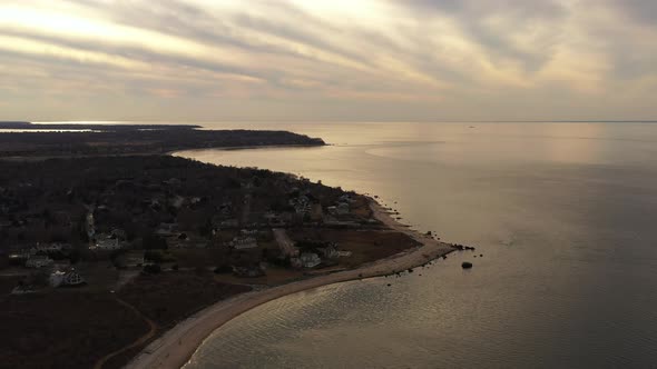 an aerial view over the eastern end of Orient Point, Long Island during sunset. The camera dolly in