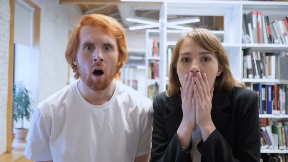 Wondering Man and Woman in Shock at Work In Office