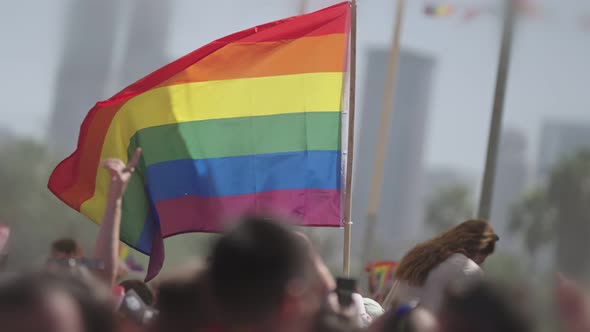LGBTQ rainbow flag waving in slow motion during the main party in a pride parade