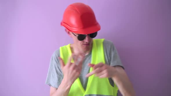 Cool builder dancing in a helmet and vest.
