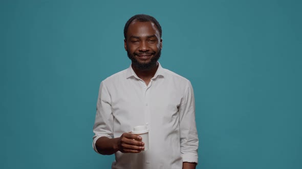 Portrait of Businessman Holding Cup of Coffee in Hand