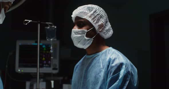 A Team of Surgeons Perform an Operation in a Bright Operating Room