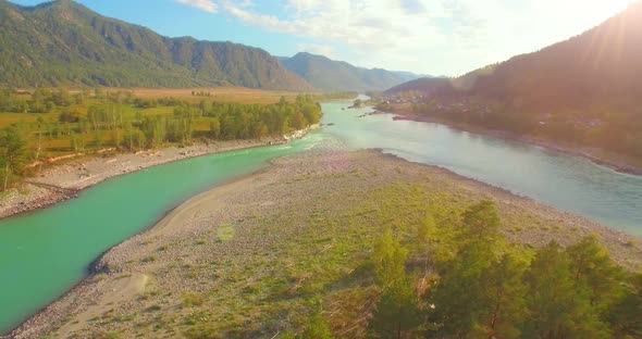 Low Altitude Flight Over Fresh Fast Mountain River with Rocks at Sunny Summer Morning.