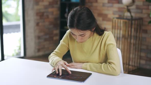 Young Woman at Home Using Digital Tablet