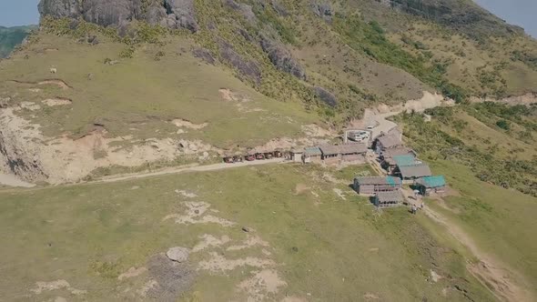 Cinematic aerial drone video of splashing ocean waves into a scenic mountains of Sabtang, Batanes in