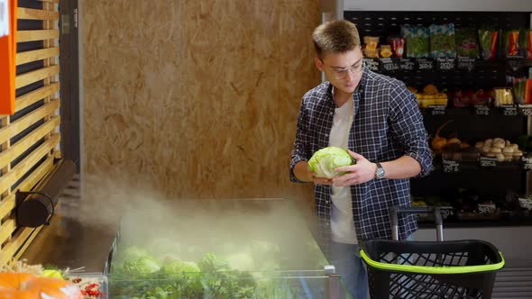 Man Buying White and Chinese Cabbage at Grocery