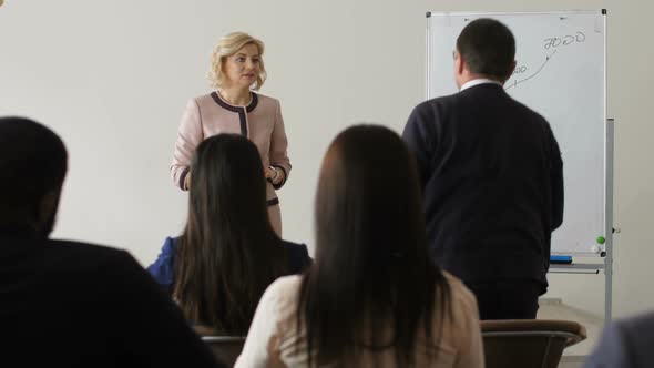 Coach Asking Group for Questions on Outlined Topic