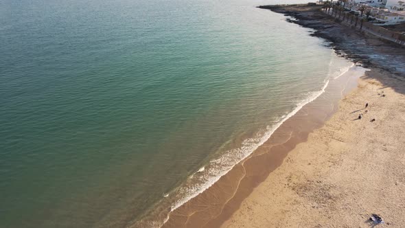 Praia da Luz seafront with golden beach sand in Algarve, Portugal. Aerial