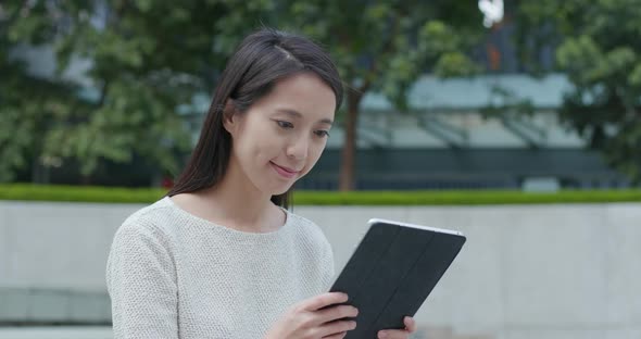 Woman use of tablet computer in city