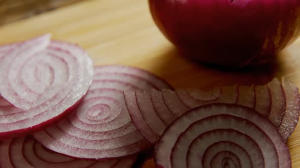 Sliced and halved onions on chopping board 4k