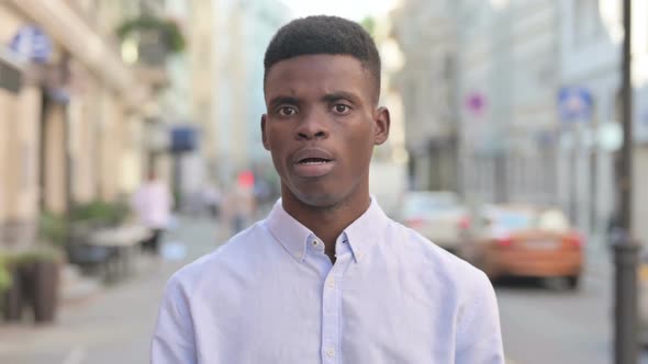 Portrait of African Man Shaking Head As No Sign Denial Outdoor