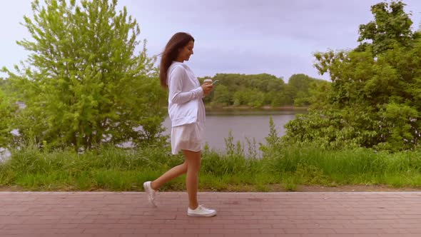 Profile Female Using Mobile Drinking Walks Along Lake