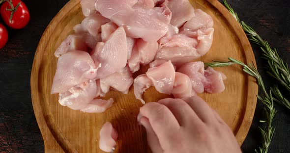 On a Cutting Board Cut Raw Chicken Fillet Into Pieces