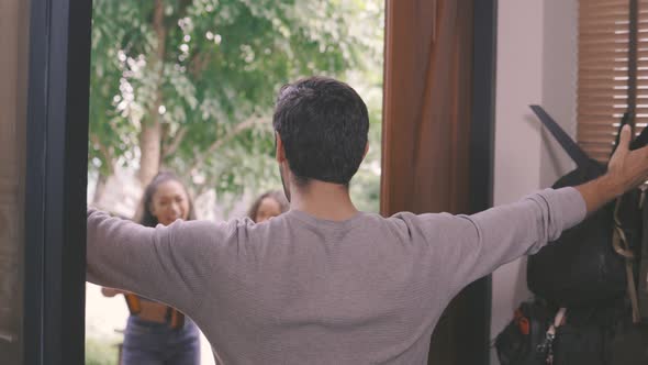 Couple Welcoming Guests to Their Home