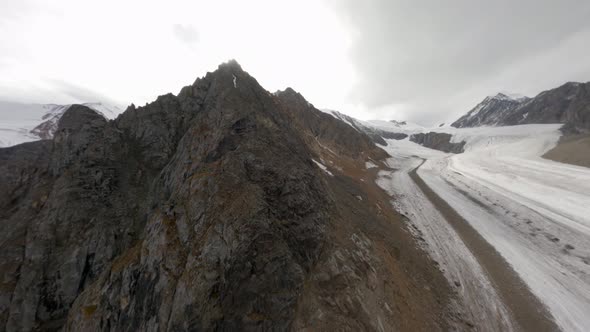 Aerial View Natural Geology Formation Mountain Stone Pebble Structure with Wind Waving Snow Summit