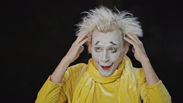 Expressive Mime Shows Acting Skills on Black Background