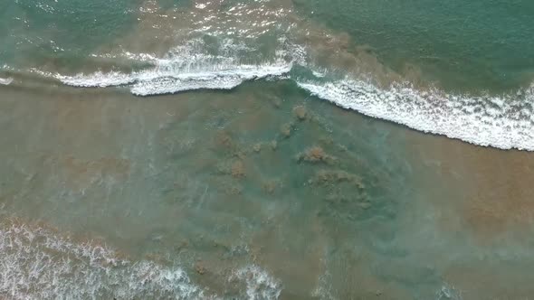 Aerial shot of esmerald waves, Pacific ocean