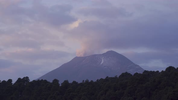Stunning view of the smoky Popocatepetl stratovolcano top in Mexico under a cloudy sky